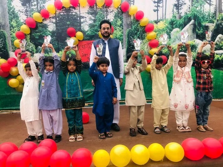 Young students celebrating with prizes on stage at Edutop